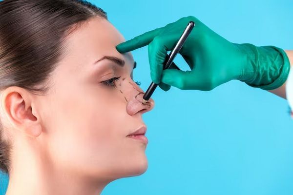 cosmetic surgeon examining female client in office. d