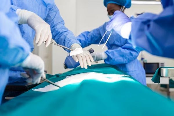 surgeon team in uniform performs an operation on a patient on bariatric surgery