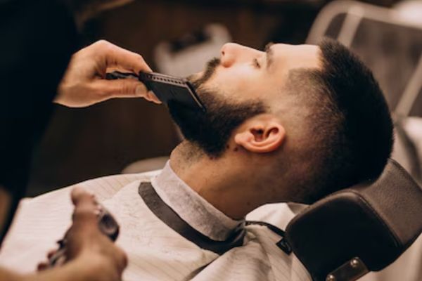 a man cutting his hair by Barbers in mexico city