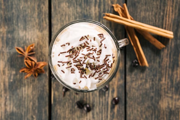 aerial view of a glass of horchata with cinnamon next to it