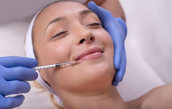 Beautiful young woman during skin treatment with hyaluronic acid in a beauty clinic