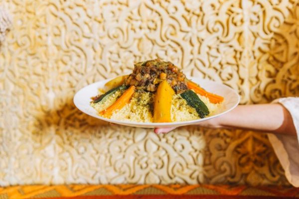 a plate of iranian food held by a hand