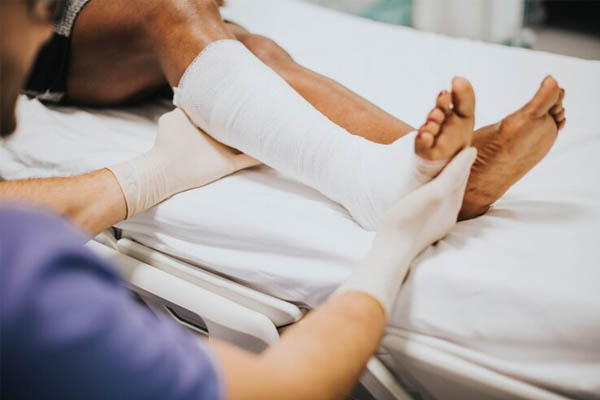 Doctor helping patient broken leg - trauma clinics