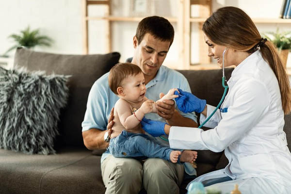 happy female doctor listening to heartbeat of little boy stethoscope medical appointment