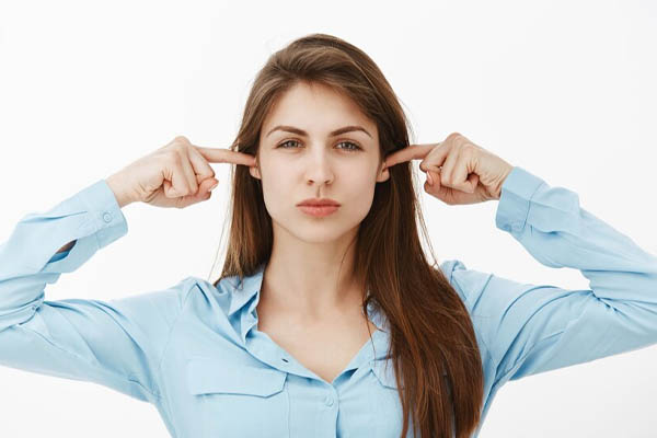 Woman coverig her ears 