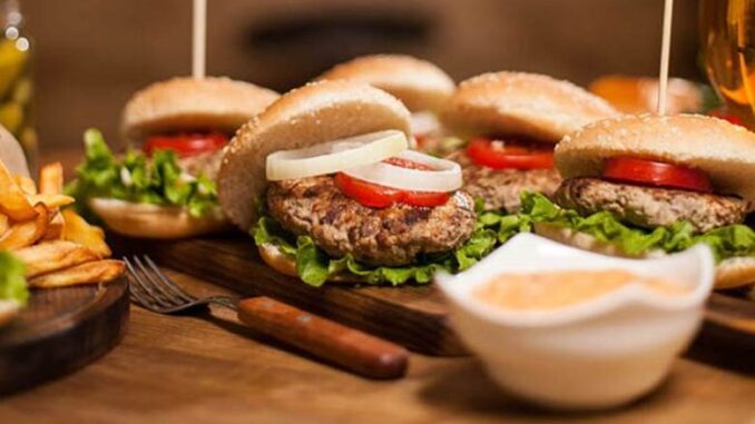table-restaurant-wooden-full-delicious-burgres-fries-fries-hamburgers-classic-sauce