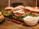 table-restaurant-wooden-full-delicious-burgres-fries-fries-hamburgers-classic-sauce