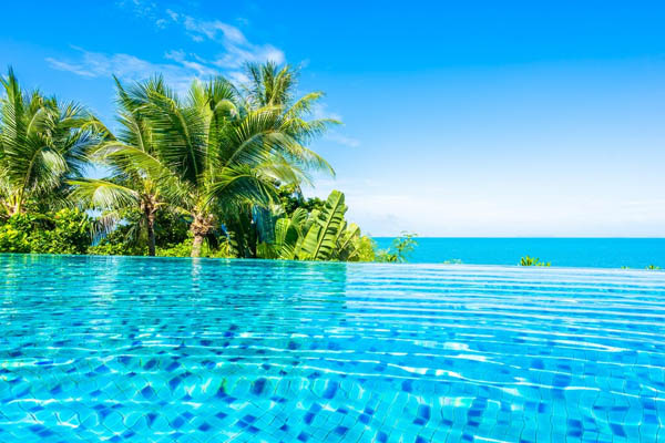 beautiful-pool-luxury-outdoor-hotel-resort-sea-ocean-around-palm tree-coconut-white-cloud-blue-sky