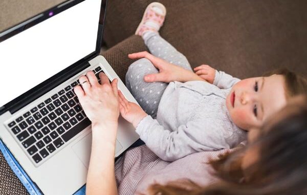 Top 10 best online baby stores in Mexico elevated-view-woman-her-daughter-using-laptop-white-screen-white